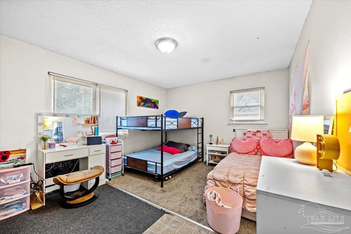 3060 Safronia Shores Road Navarre, FL 32566 - Photo 19 of 28 a bedroom with furniture and a window