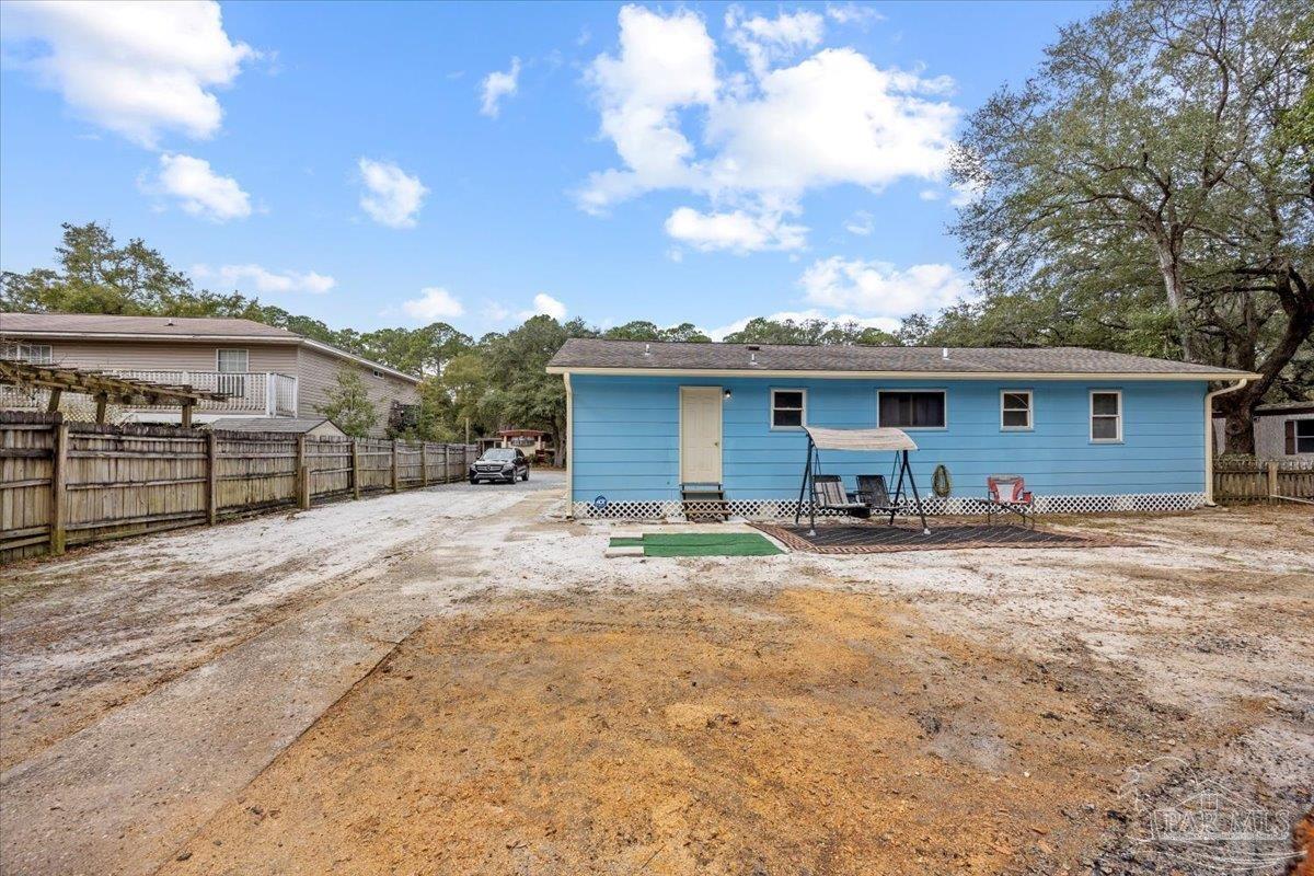 3060 Safronia Shores Road Navarre, FL 32566 - Photo 21 of 28 a view of a house with backyard and a tree