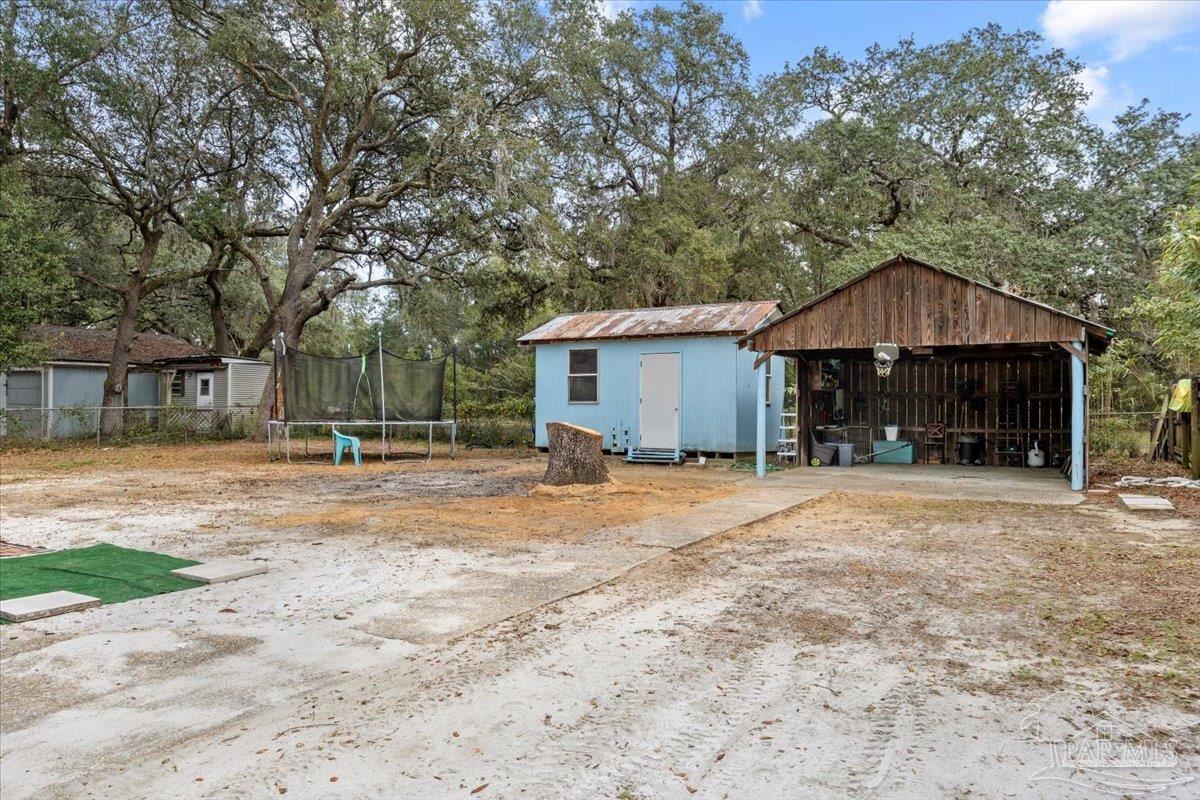 3060 Safronia Shores Road Navarre, FL 32566 - Photo 22 of 28 a front view of a house with a yard and garage
