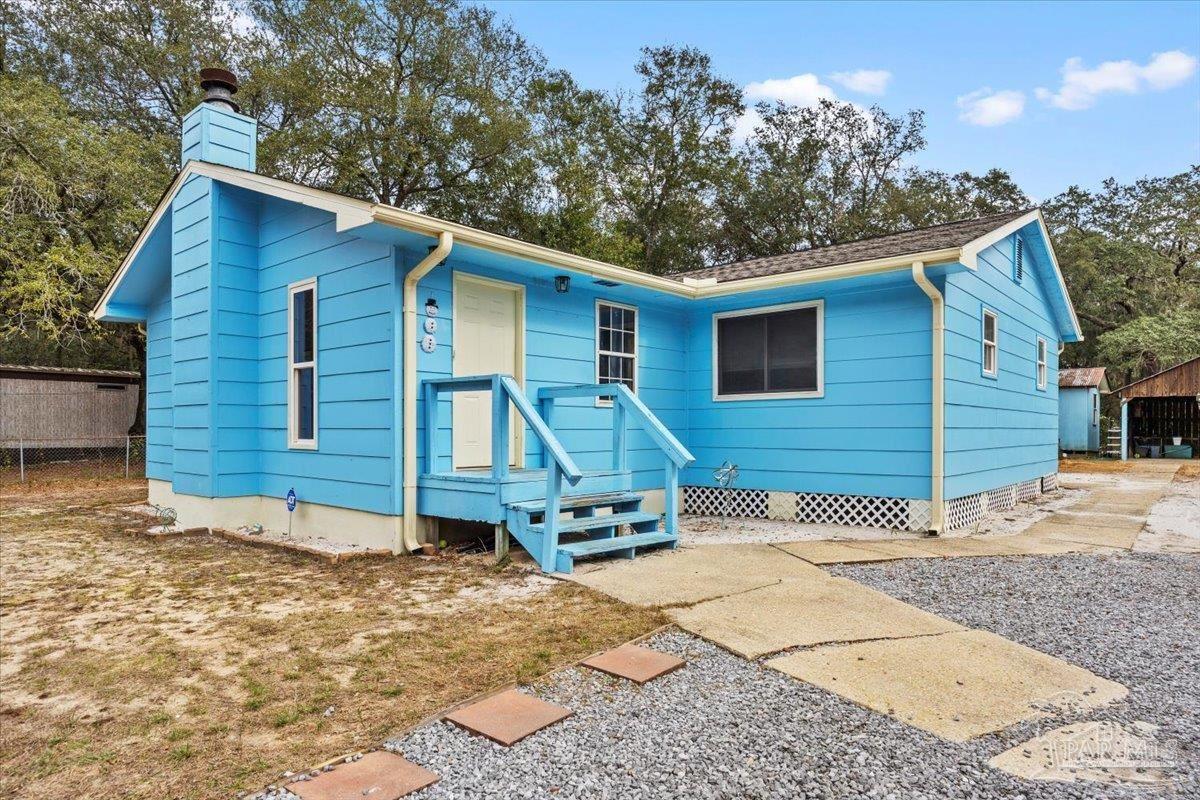 3060 Safronia Shores Road Navarre, FL 32566 - Photo 23 of 28 a front view of a house with a yard