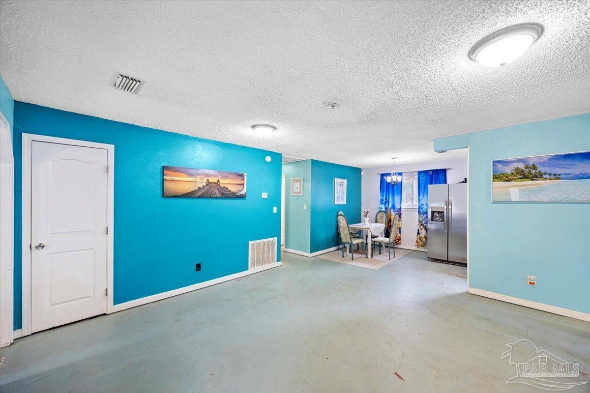 3060 Safronia Shores Road Navarre, FL 32566 - Photo 8 of 28 a view of a livingroom with furniture and a flat screen tv