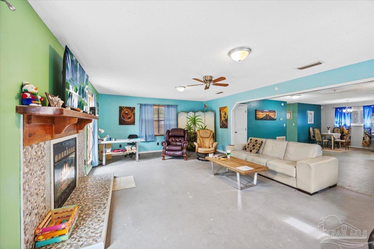 3060 Safronia Shores Road Navarre, FL 32566 - Photo 9 of 28 a living room with furniture and a fireplace