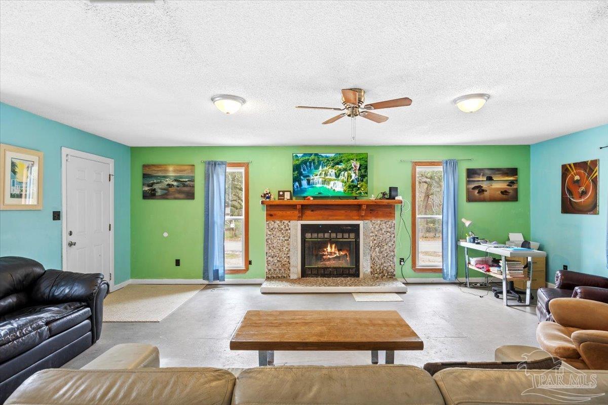 3060 Safronia Shores Road Navarre, FL 32566 - Photo 10 of 28 a living room with furniture and a fireplace