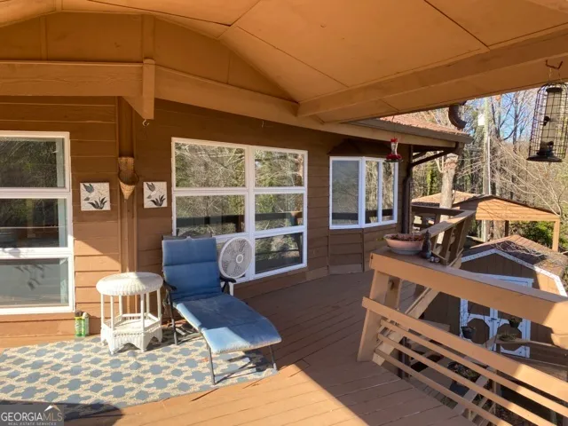 a view of a balcony with chair and a potted plant