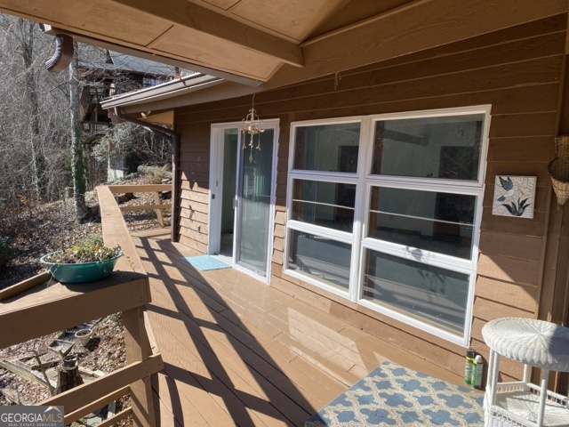 373 Western Way Rabun Gap, GA 30568 - Photo 17 of 30 a view of a balcony with chair and a potted plant