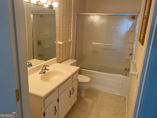 a view of a room with furniture and window