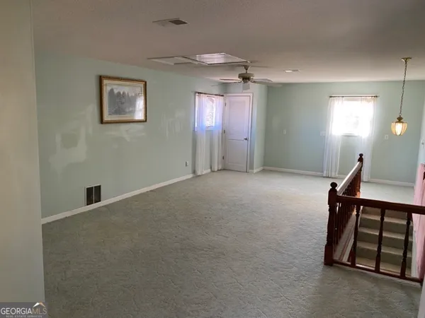 a view of an entryway with wooden floor