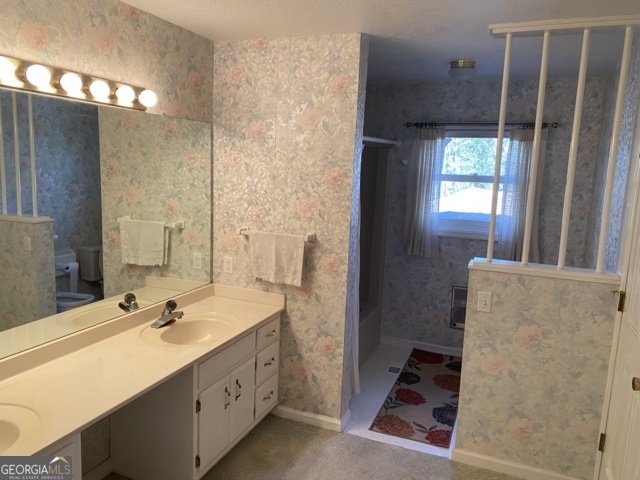 373 Western Way Rabun Gap, GA 30568 - Photo 7 of 30 a bathroom with a double vanity sink a mirror and a shower