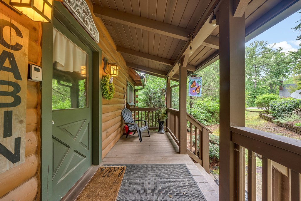 149 Mountain Springs Road Warm Springs, GA 31830 - Photo 6 of 43 a porch with chairs next to a yard
