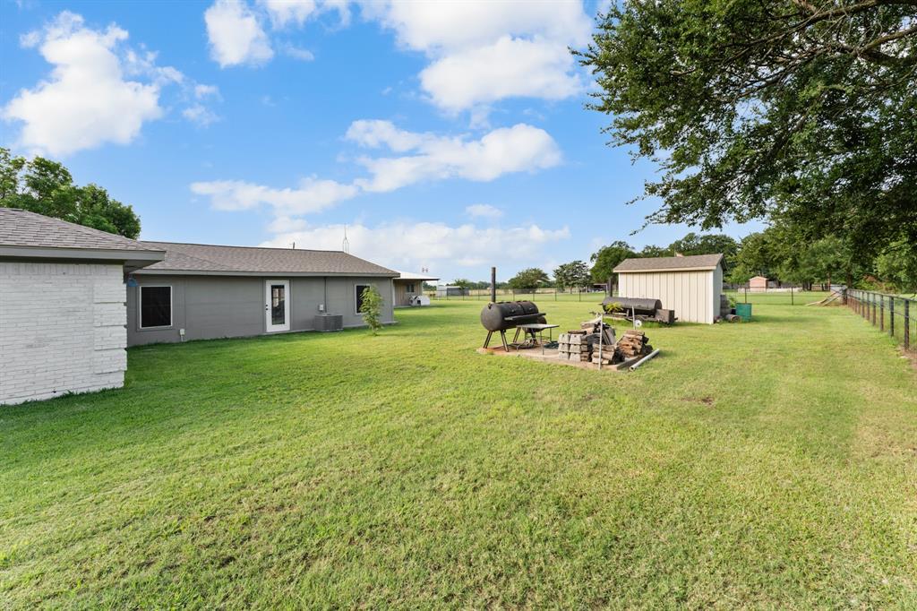 380 Farr Altom Road Seagoville, TX 75159 - Photo 21 of 30 Expansive green lawn with a white brick and gray siding exterior