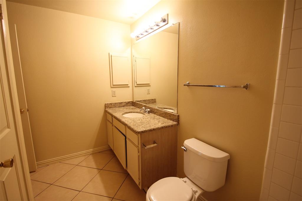 2524 Preston Road, Unit 1203 Plano, TX 75093 - Photo 15 of 30 a bathroom with a granite countertop sink toilet and shower