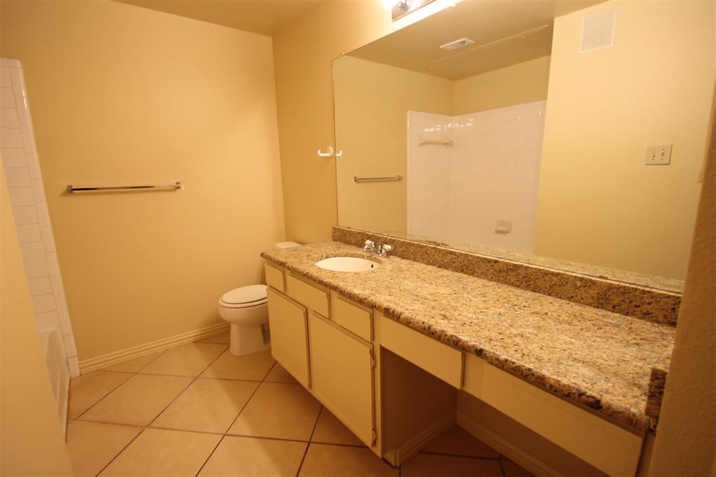 2524 Preston Road, Unit 1203 Plano, TX 75093 - Photo 16 of 30 a bathroom with a granite countertop sink and a mirror