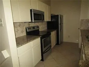 a kitchen with a stove microwave and refrigerator
