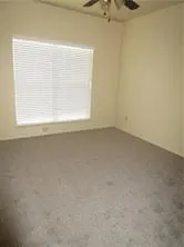 a view of empty room with a fireplace