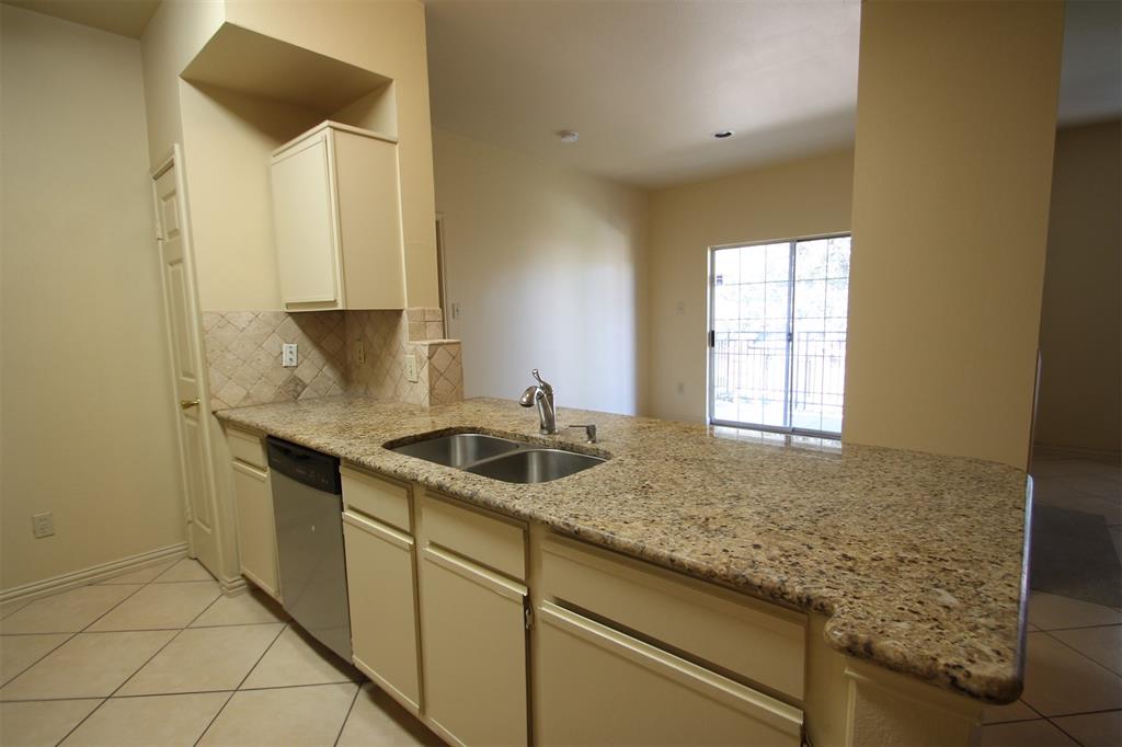 2524 Preston Road, Unit 1203 Plano, TX 75093 - Photo 6 of 30 a kitchen with granite countertop sink and cabinets
