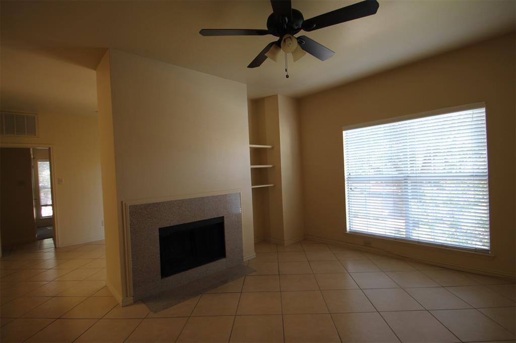 2524 Preston Road, Unit 1203 Plano, TX 75093 - Photo 7 of 30 a view of an empty room with a fireplace and a window