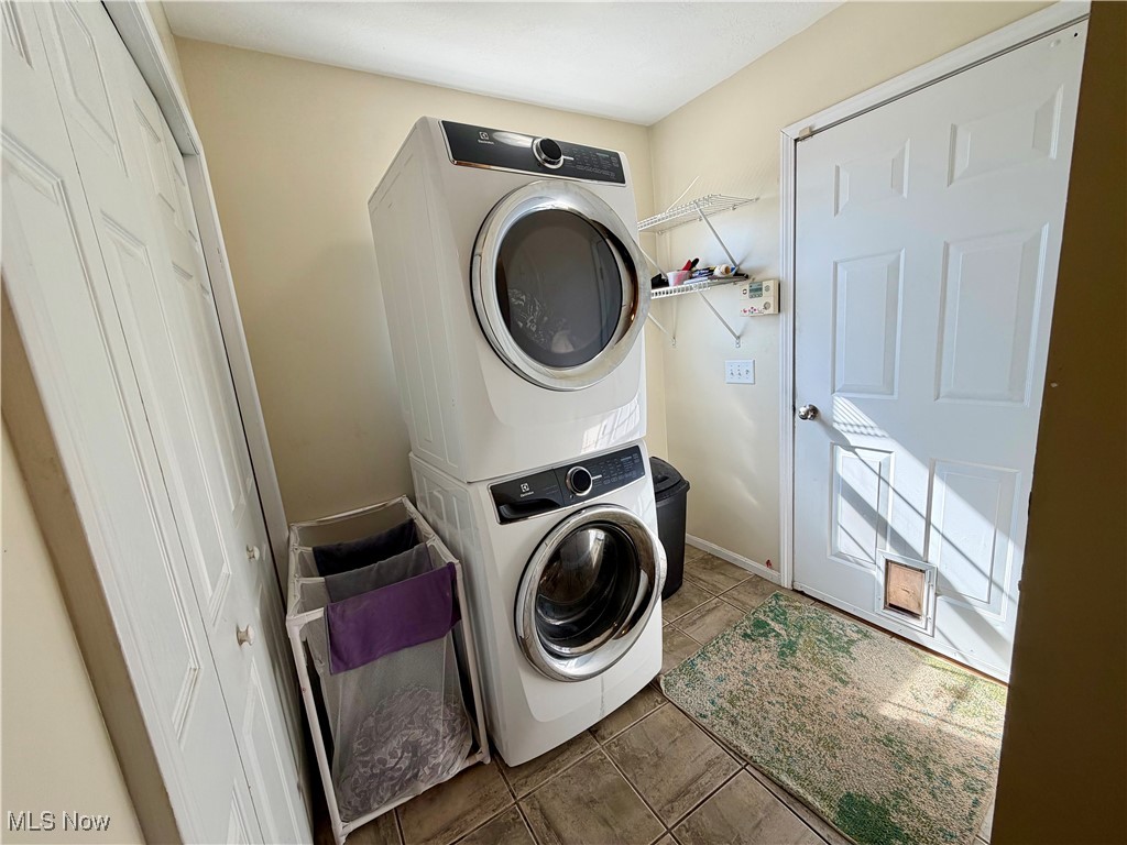 7374 Virginia Road Atwater, OH 44201 - Photo 18 of 49 Washroom featuring stacked washing machine and dryer and tile patterned floors
