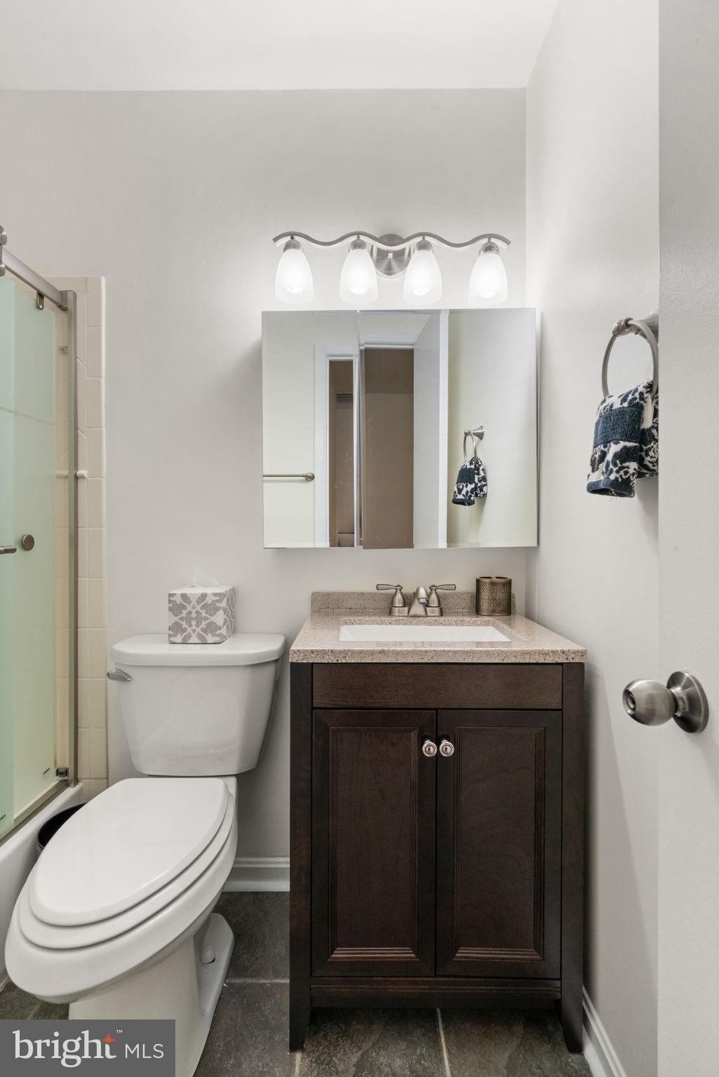 7610 Bland Drive Manassas, VA 20109 - Photo 17 of 43 a bathroom with a granite countertop toilet sink and mirror