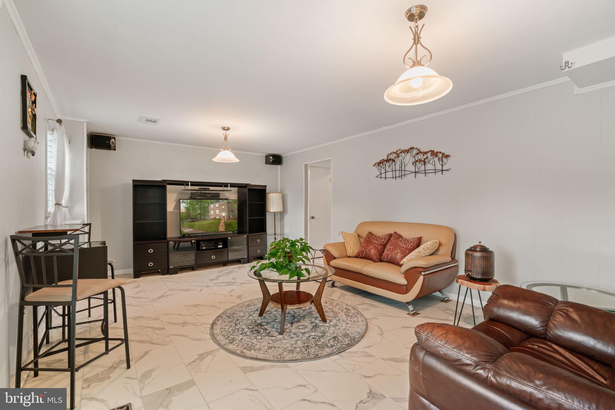 7610 Bland Drive Manassas, VA 20109 - Photo 27 of 43 a living room with furniture and a flat screen tv