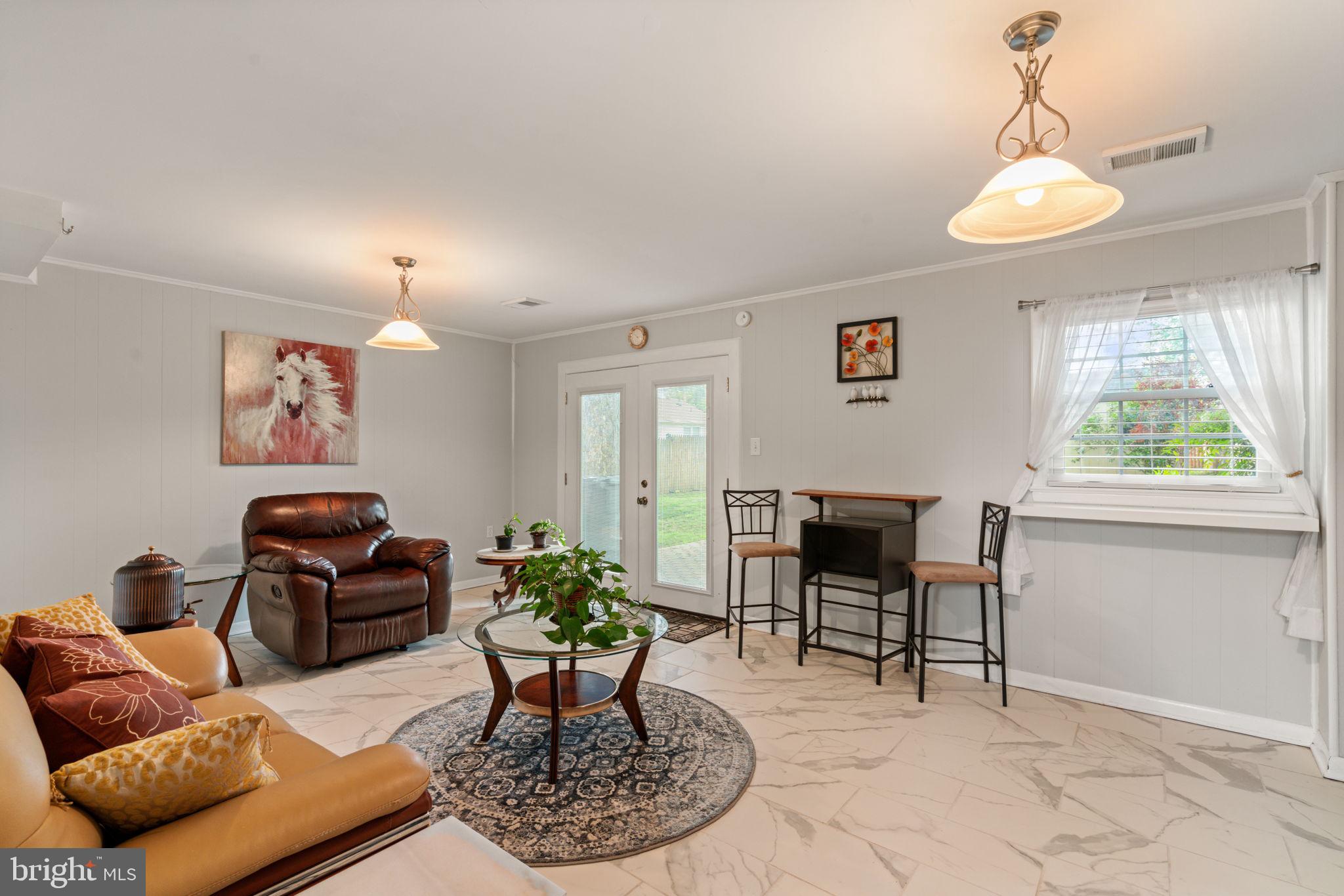 7610 Bland Drive Manassas, VA 20109 - Photo 29 of 43 a living room with furniture chandelier and a window