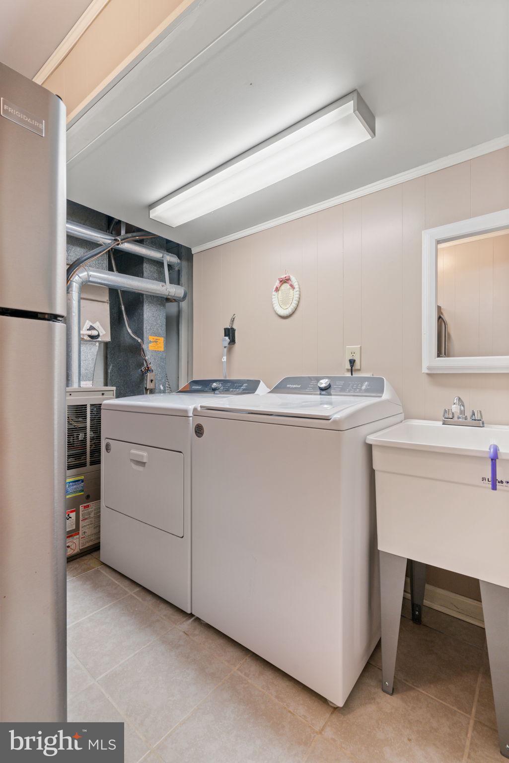 7610 Bland Drive Manassas, VA 20109 - Photo 33 of 43 a utility room with cabinets washer and dryer