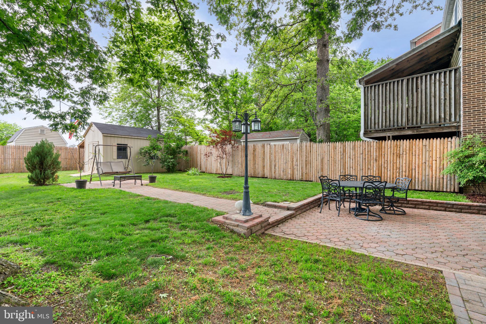 7610 Bland Drive Manassas, VA 20109 - Photo 35 of 43 a garden with a bench in front of the house
