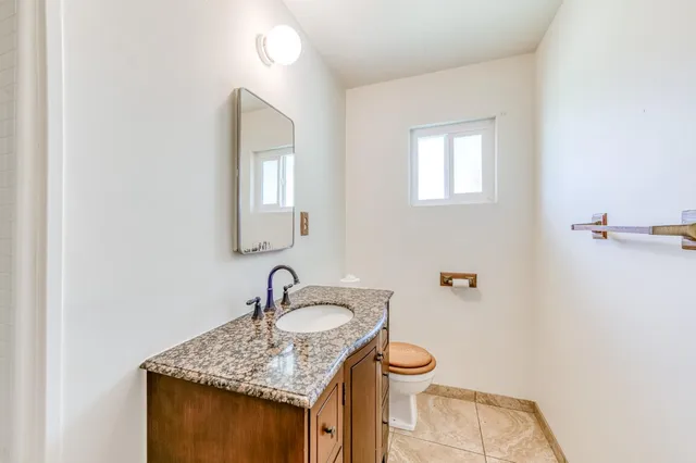 a bathroom with a bathtub sink and mirror