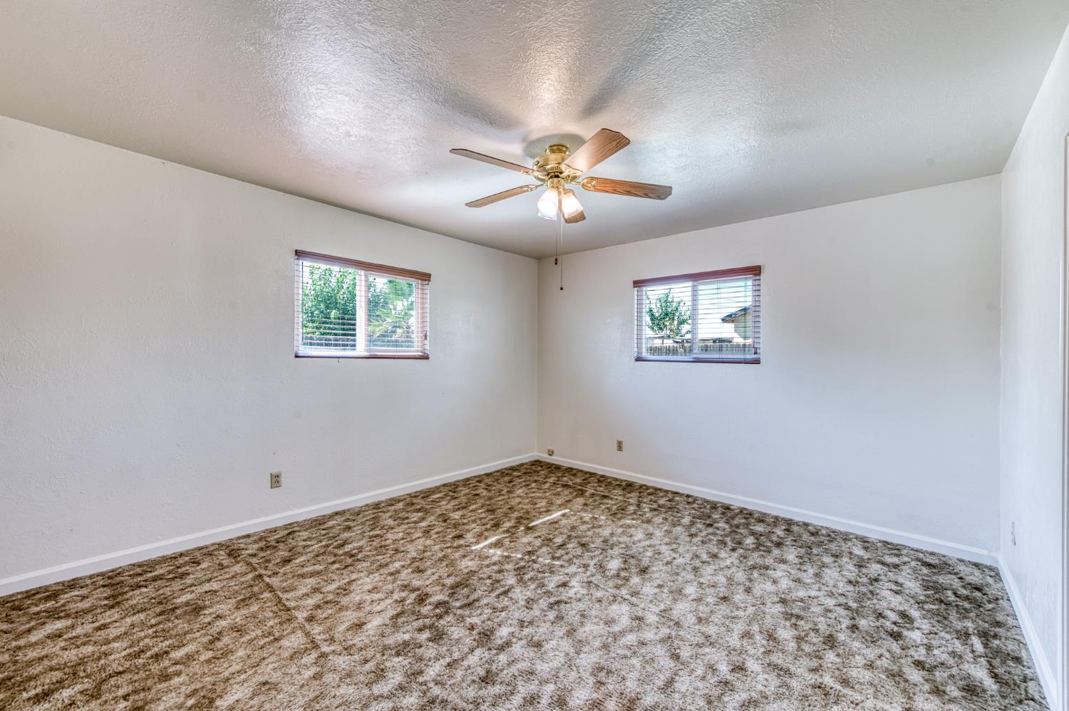 8625 La Vaca Way Hanford, CA 93230 - Photo 21 of 33 a view of a big room with wooden floor and chandelier fan