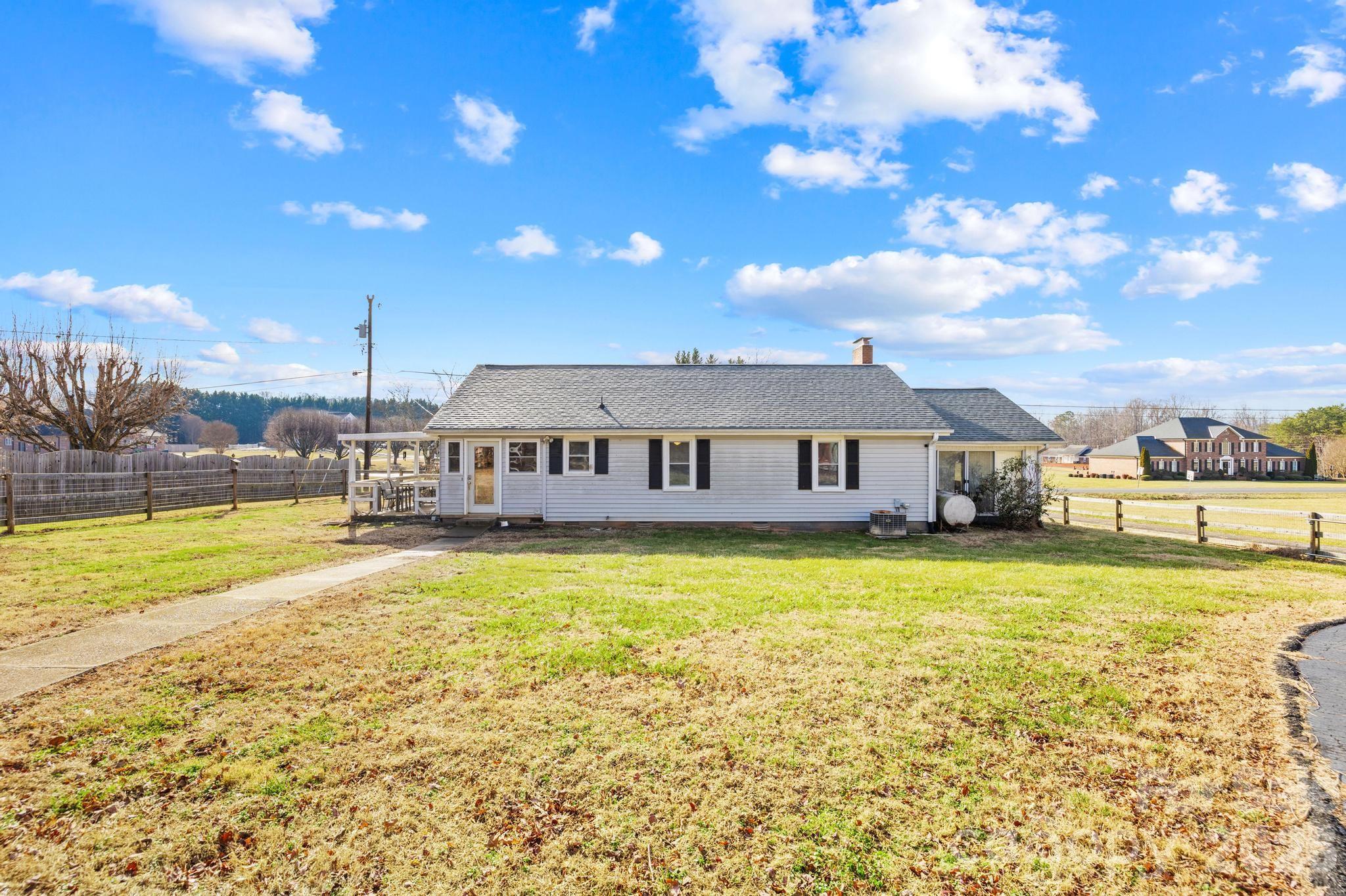 3060 Poplar Springs Road State Road, NC 28676 - Photo 17 of 38 a view of a house with a swimming pool and a yard