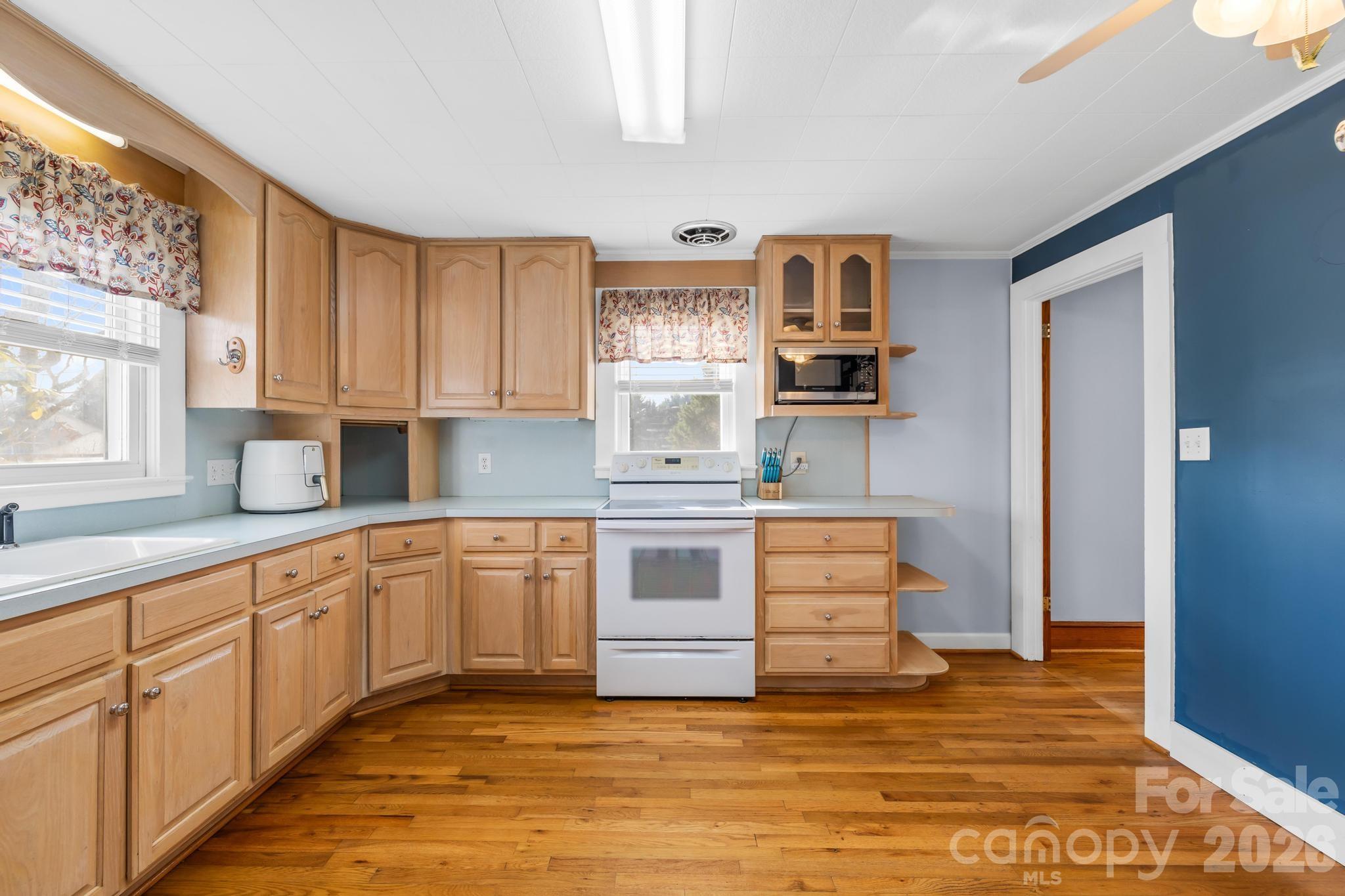 3060 Poplar Springs Road State Road, NC 28676 - Photo 29 of 38 a kitchen with stainless steel appliances granite countertop a stove and cabinets
