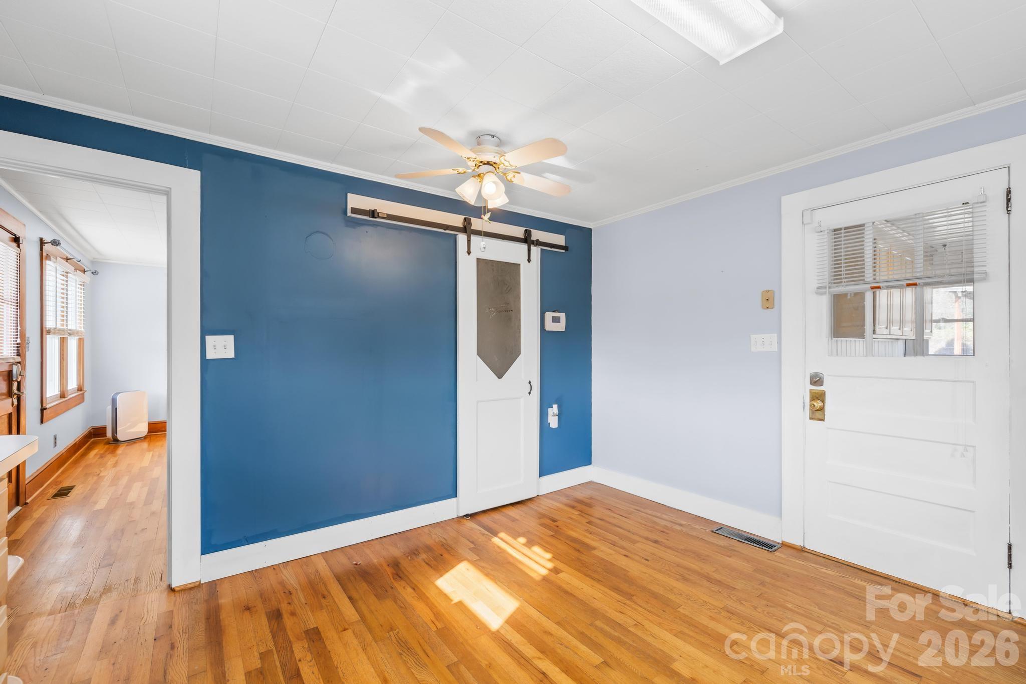 3060 Poplar Springs Road State Road, NC 28676 - Photo 30 of 38 a view of a livingroom with wooden floor and a ceiling fan