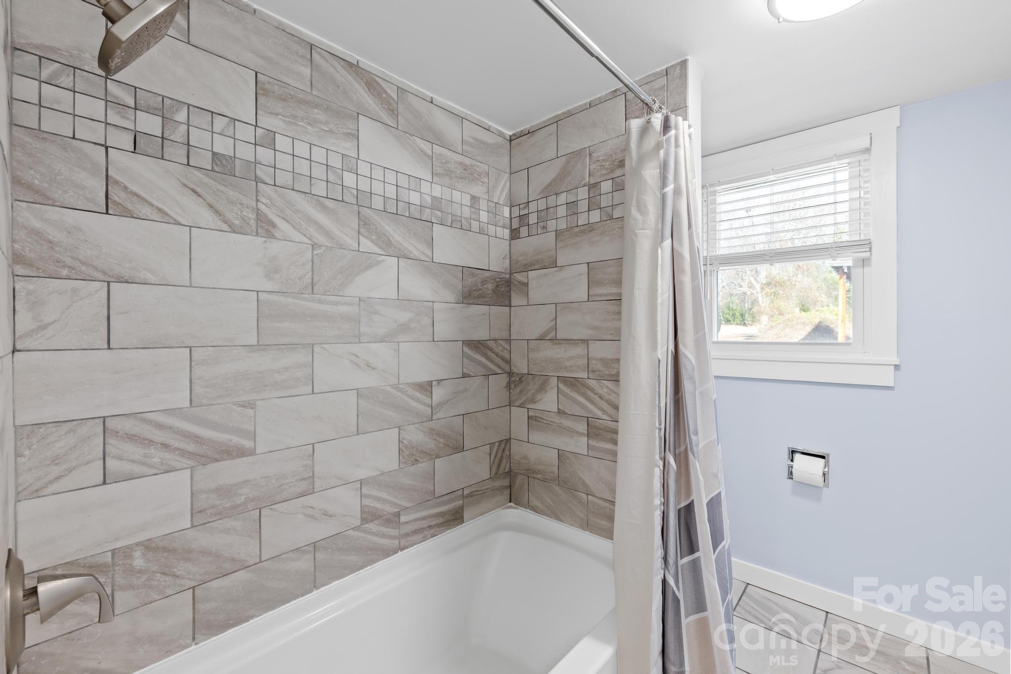 3060 Poplar Springs Road State Road, NC 28676 - Photo 33 of 38 a bathroom with a bathtub and shower