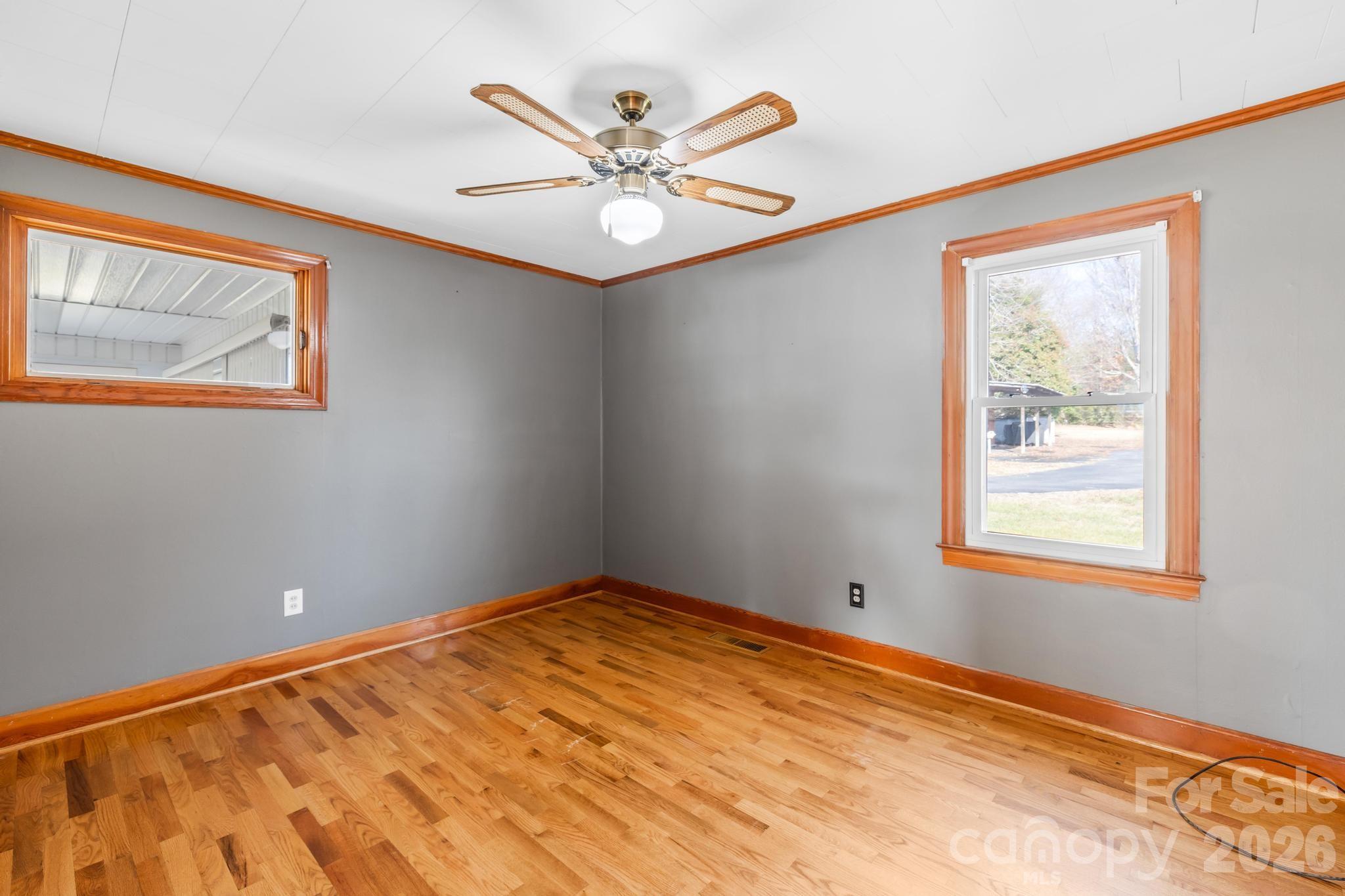 3060 Poplar Springs Road State Road, NC 28676 - Photo 35 of 38 a view of an empty room with window and wooden floor