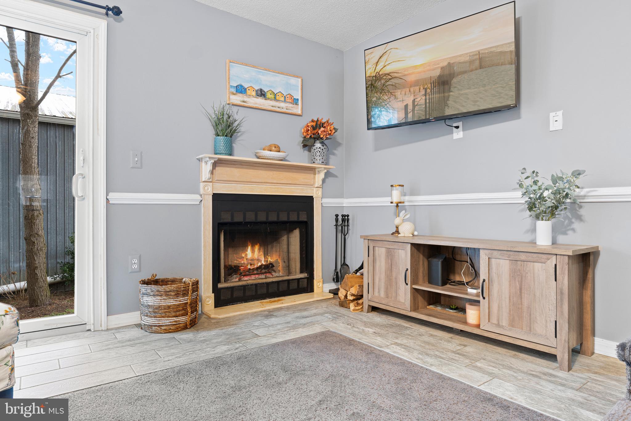 9815 Stephen Decatur Highway, Unit 14 Ocean City, MD 21842 - Photo 15 of 30 a living room with furniture and a fireplace