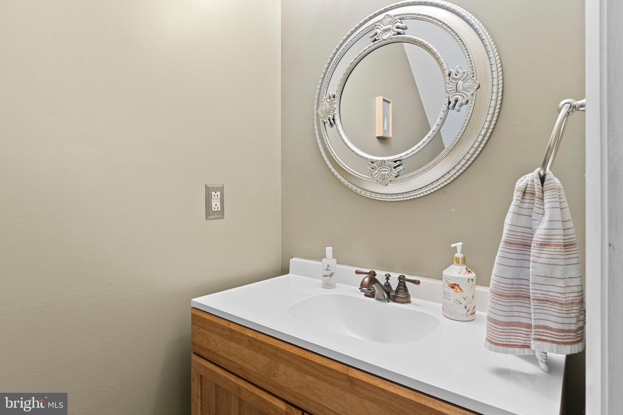 9815 Stephen Decatur Highway, Unit 14 Ocean City, MD 21842 - Photo 16 of 30 a bathroom with a sink and a mirror