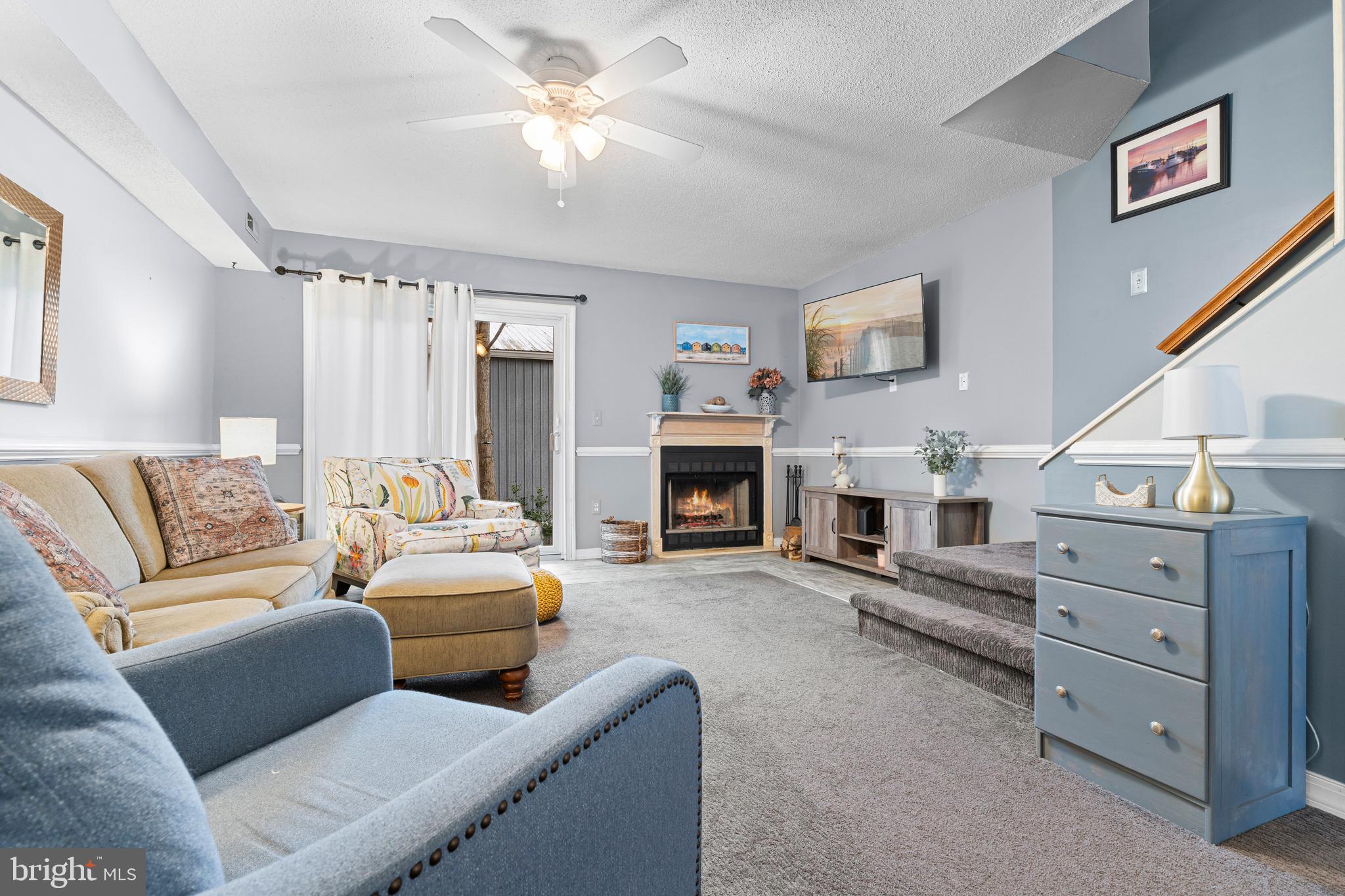 9815 Stephen Decatur Highway, Unit 14 Ocean City, MD 21842 - Photo 17 of 30 a living room with furniture and a fireplace