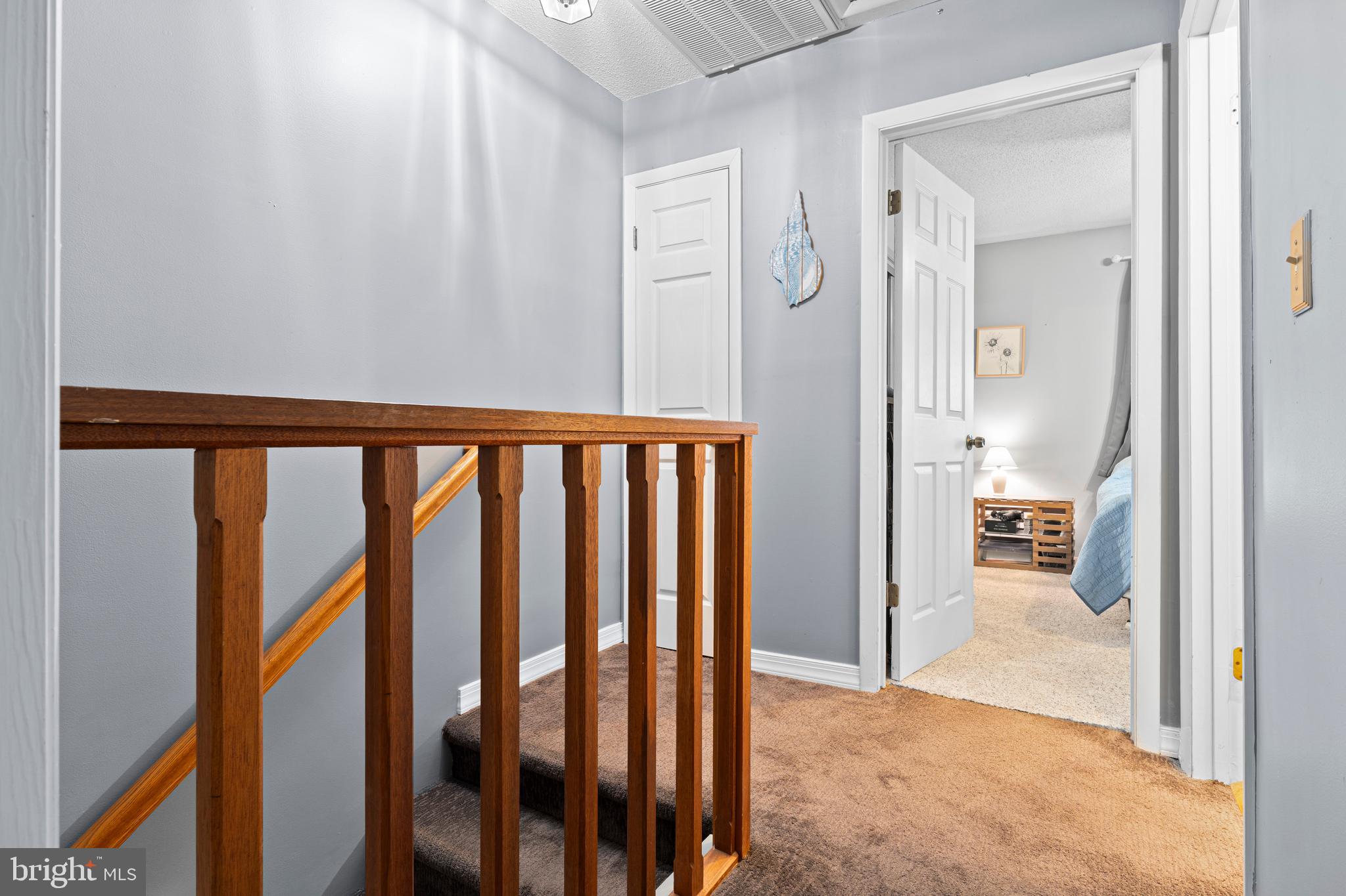 9815 Stephen Decatur Highway, Unit 14 Ocean City, MD 21842 - Photo 18 of 30 a view of a hallway with wooden floor and a bathroom