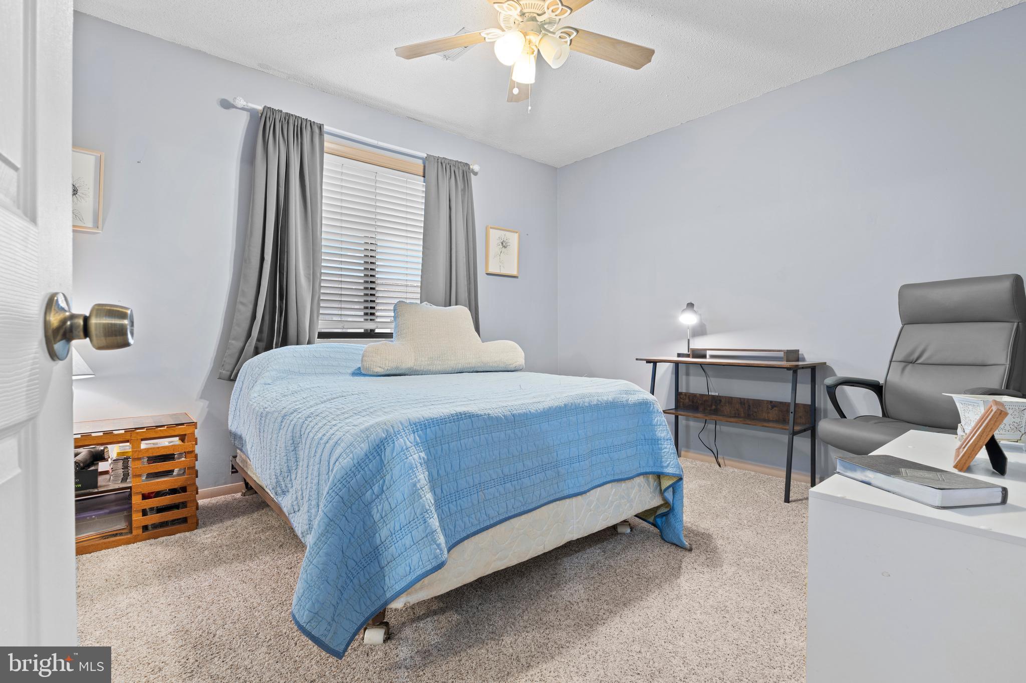 9815 Stephen Decatur Highway, Unit 14 Ocean City, MD 21842 - Photo 19 of 30 a bedroom with a bed and a chandelier