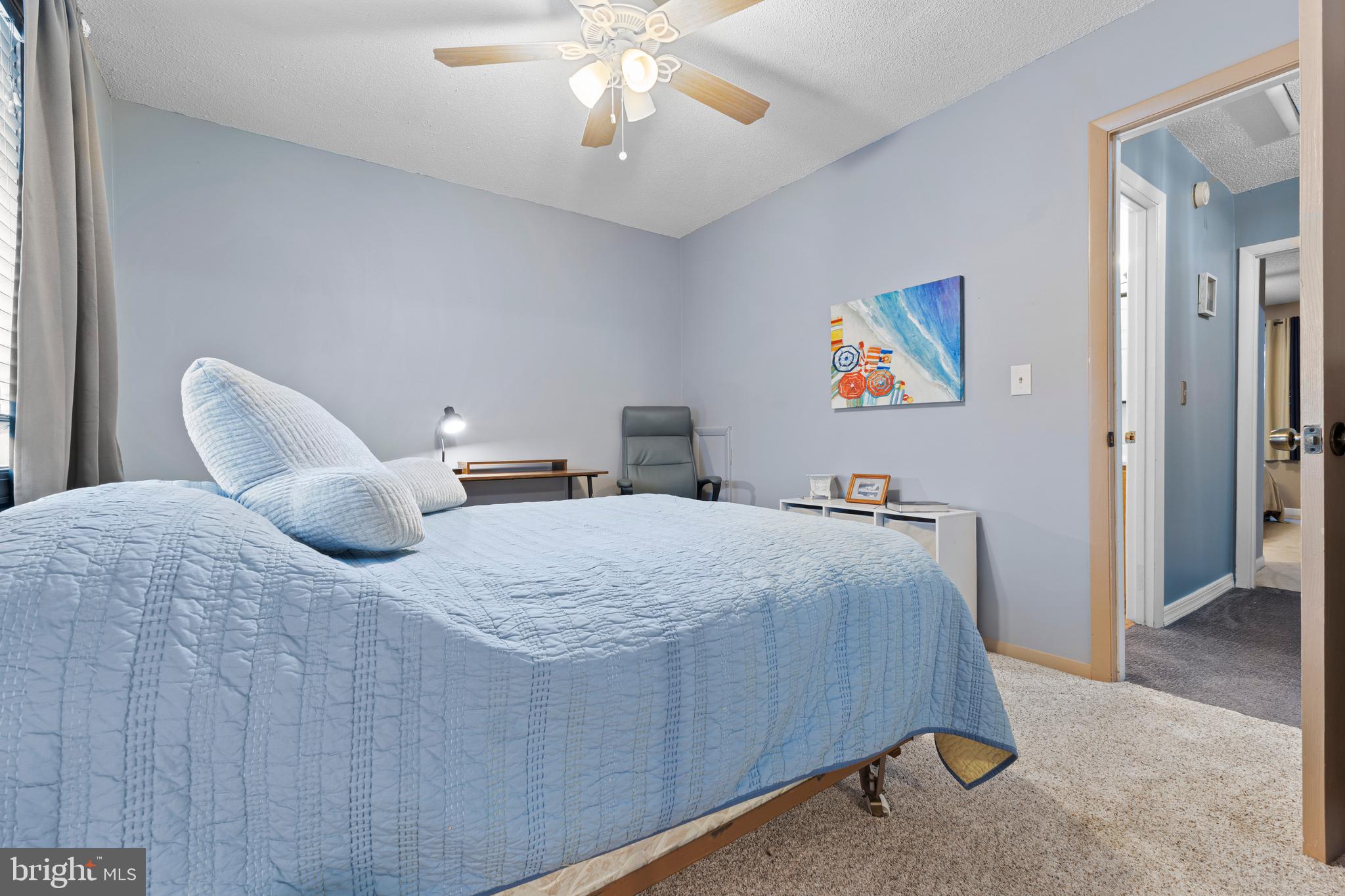 9815 Stephen Decatur Highway, Unit 14 Ocean City, MD 21842 - Photo 20 of 30 a bedroom with a bed and a chandelier