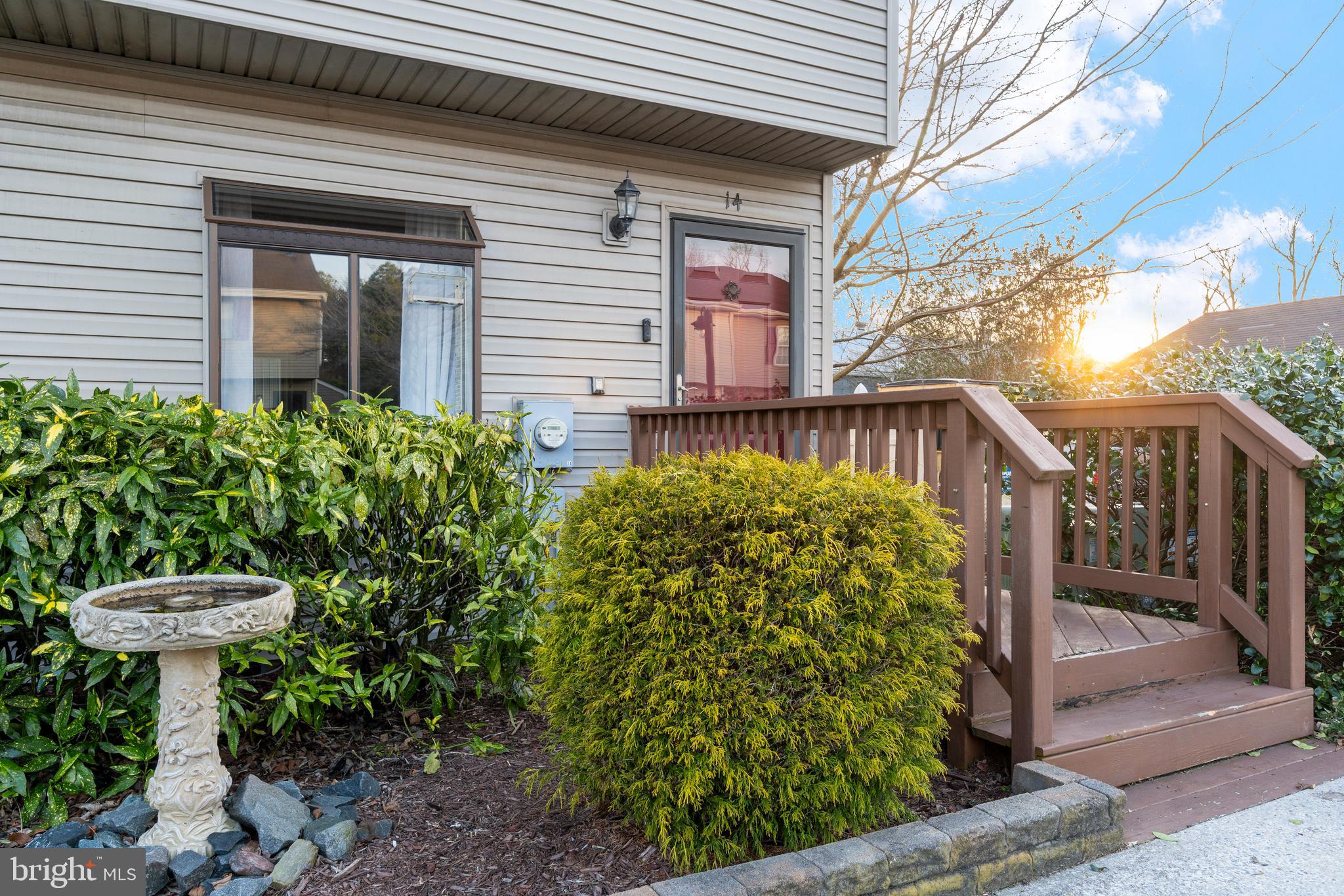 9815 Stephen Decatur Highway, Unit 14 Ocean City, MD 21842 - Photo 2 of 30 a view of a house with brick walls and a small yard