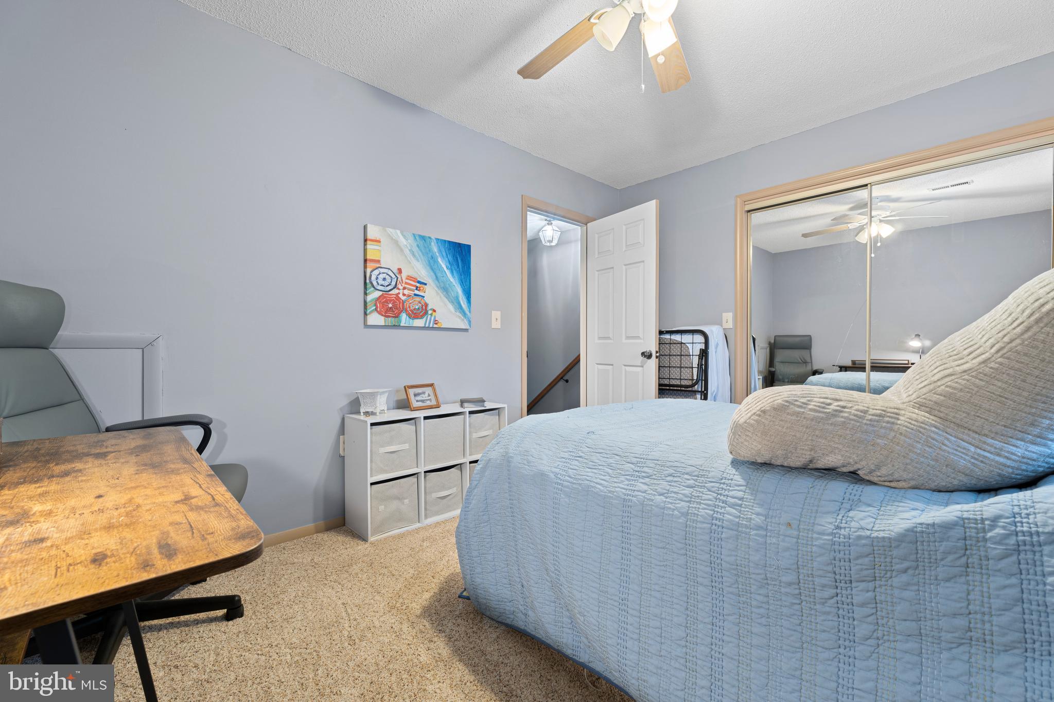 9815 Stephen Decatur Highway, Unit 14 Ocean City, MD 21842 - Photo 21 of 30 a bedroom with a bed and a chandelier
