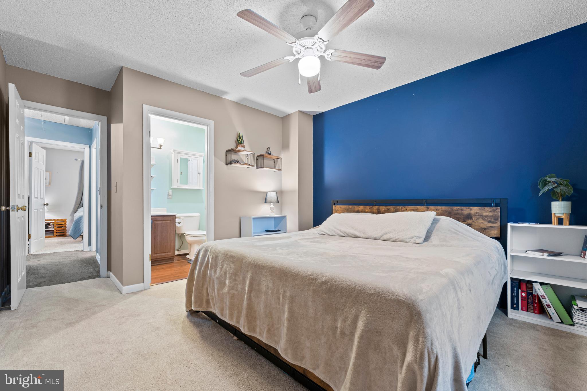 9815 Stephen Decatur Highway, Unit 14 Ocean City, MD 21842 - Photo 25 of 30 a bedroom with a bed and a chandelier