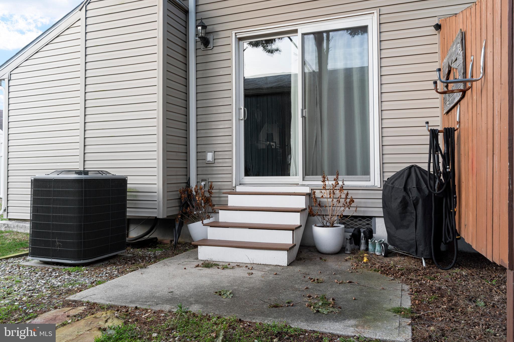 9815 Stephen Decatur Highway, Unit 14 Ocean City, MD 21842 - Photo 29 of 30 a view of a patio with a chairs and a potted plant