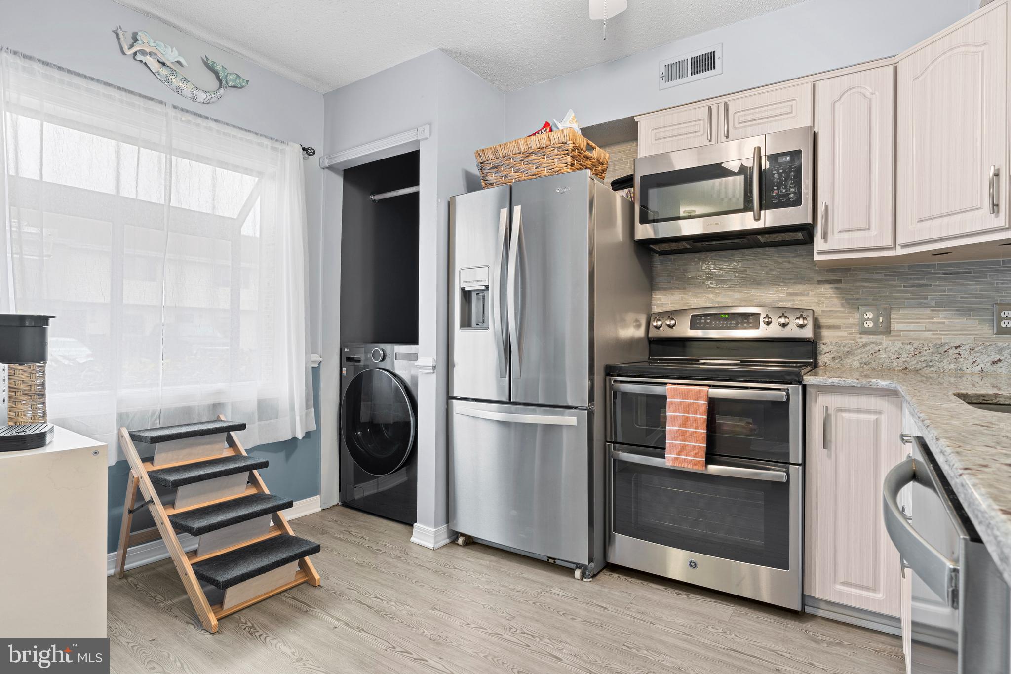 9815 Stephen Decatur Highway, Unit 14 Ocean City, MD 21842 - Photo 5 of 30 a kitchen with cabinets and steel stainless steel appliances