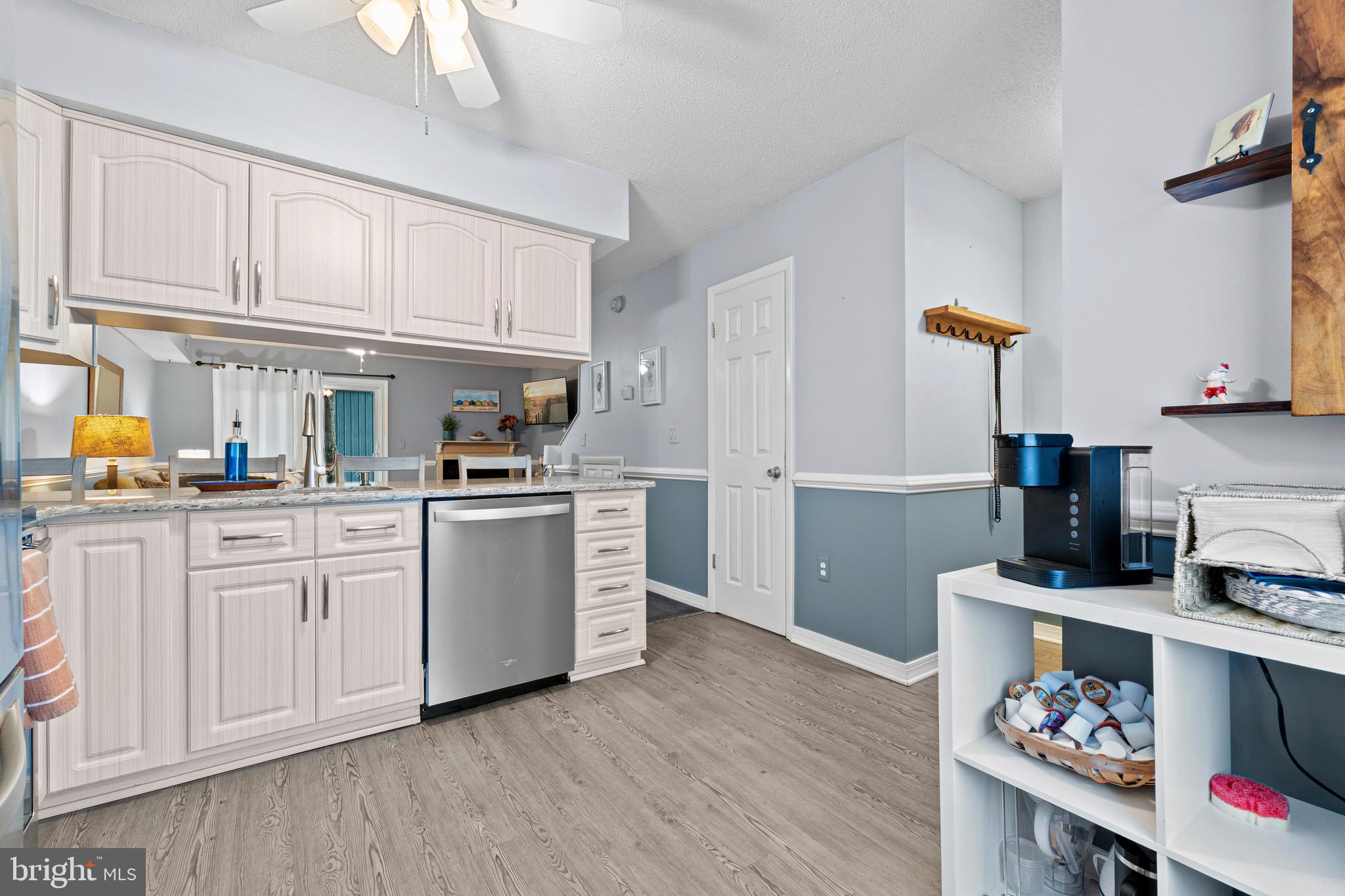 9815 Stephen Decatur Highway, Unit 14 Ocean City, MD 21842 - Photo 6 of 30 a kitchen with cabinets and wooden floor