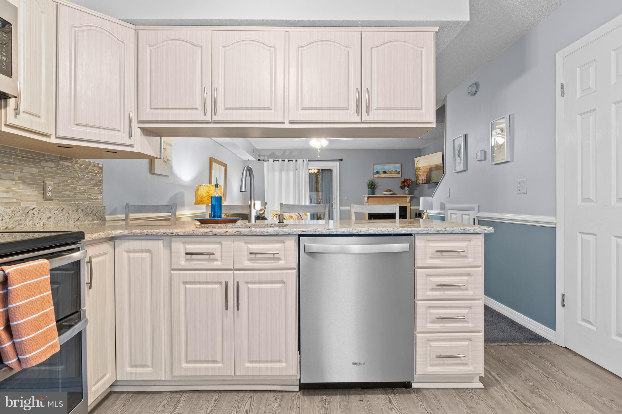 9815 Stephen Decatur Highway, Unit 14 Ocean City, MD 21842 - Photo 8 of 30 a kitchen with stainless steel appliances granite countertop a sink and dishwasher with white cabinets