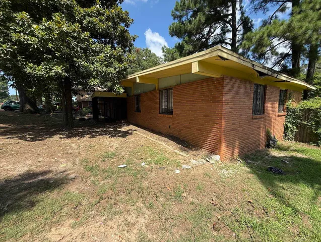 a backyard of a house with large trees