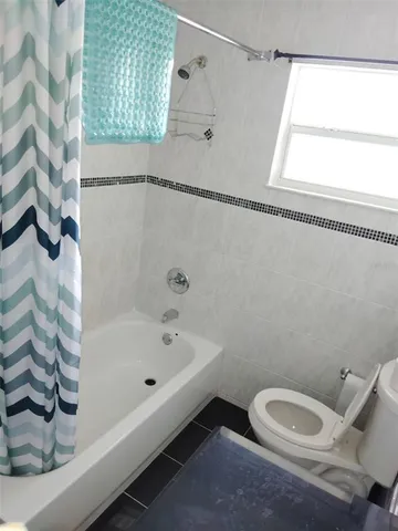 a bathroom with a toilet and a bathtub