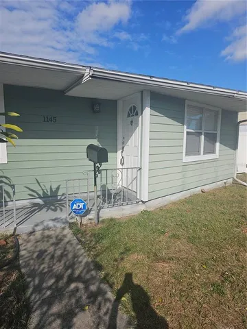 a view of a backyard with table and chairs and potted plants