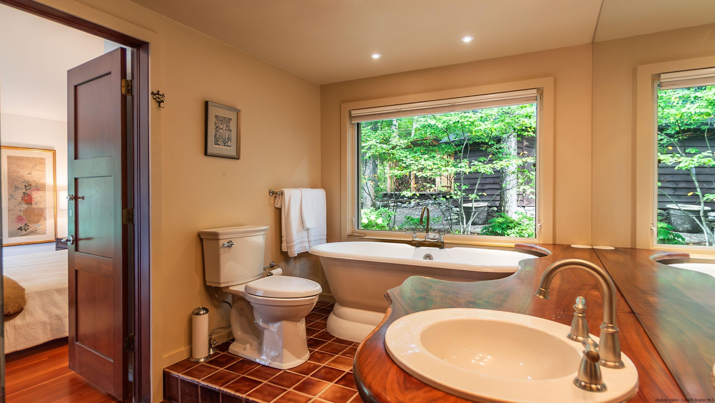 310 Jims Road Mount Tremper, NY 12457 - Photo 22 of 35 a bathroom with a sink toilet mirror and next to a window